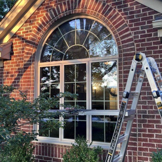 Cedarburg home with new energy-efficient 3-panel and custom round top windows installed by Modern Exterior, enhancing curb appeal and comfort