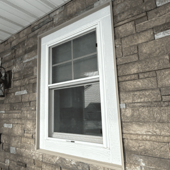 After photo of updated window trim on an Oconomowoc, WI home with Versetta Stone accents and Prem Pointe siding, completed by Modern Exterior.
