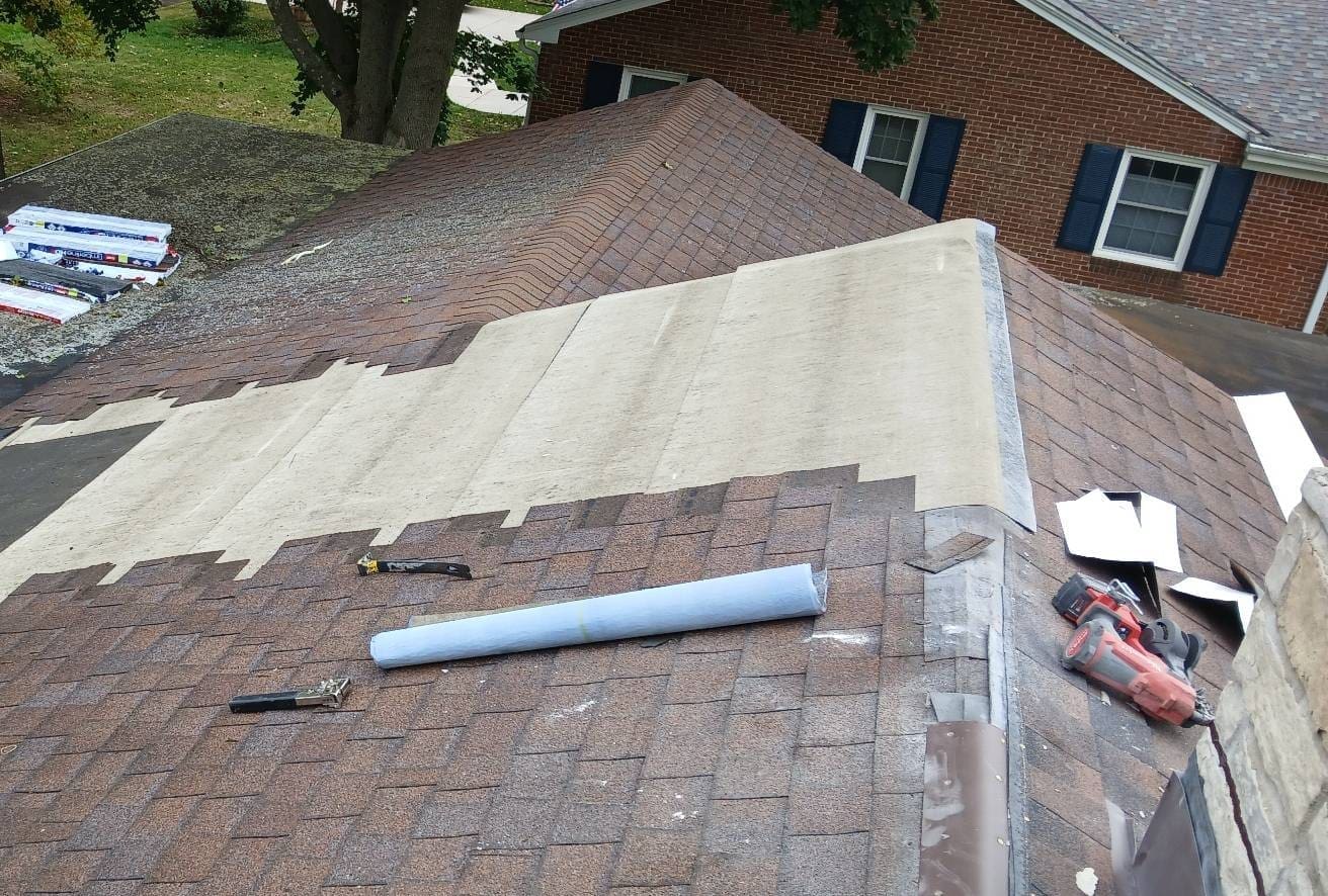 Roof repair in Bayside after chimney removal, showing new underlayment installation.