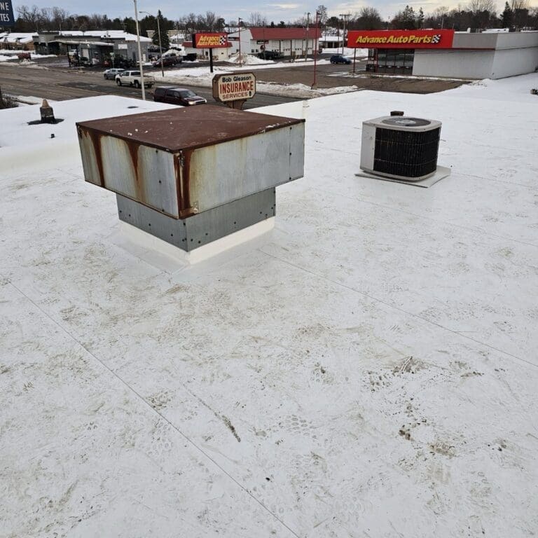 Completed PVC commercial roof at Take 5 in Wisconsin Rapids with new membrane, sealed penetrations, and rooftop equipment reinstalled
