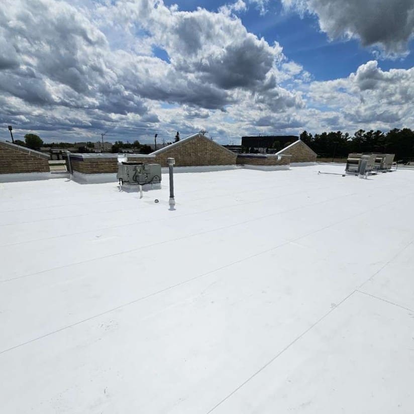 Completed commercial roof replacement at Central Bark Sussex featuring new white PVC membrane with clean seams and rooftop units reinstalled