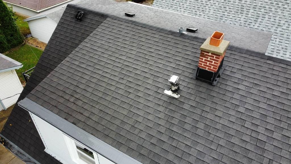 To ensure proper ventilation and prevent pest intrusion, we removed and replaced shingles to install a new 6-inch Broan kitchen exhaust vent cap with an integrated pest screen. We added an ice and water barrier around the installation for code compliance and enhanced sealing. We also tuned up the chimney flashing sealants to maintain a watertight seal, completing the project with thorough site cleanup and debris removal.