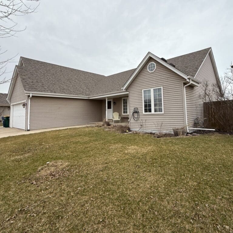 Oak Creek home before exterior renovation showing outdated siding, minimal trim detail, and no stone accent