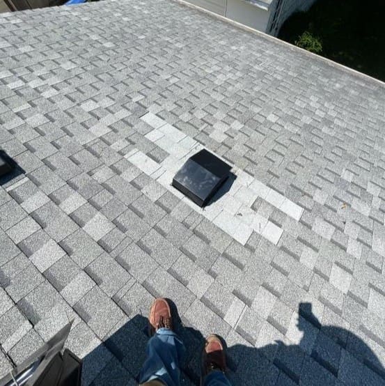 Roof vent repair with new flashing and sealant applied to prevent water intrusion.