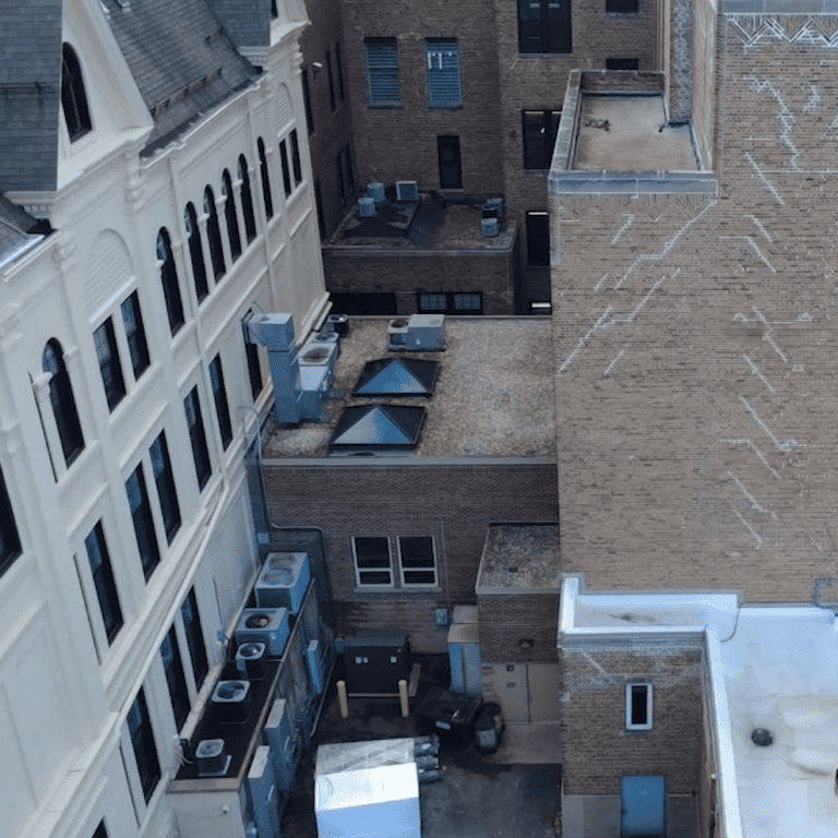 Existing flat roof section before replacement as part of a large-scale commercial roofing project in Milwaukee.