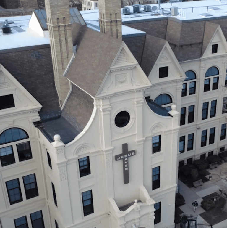 Existing steep-slope shingle roof before a large-scale commercial roof replacement on a Milwaukee building.