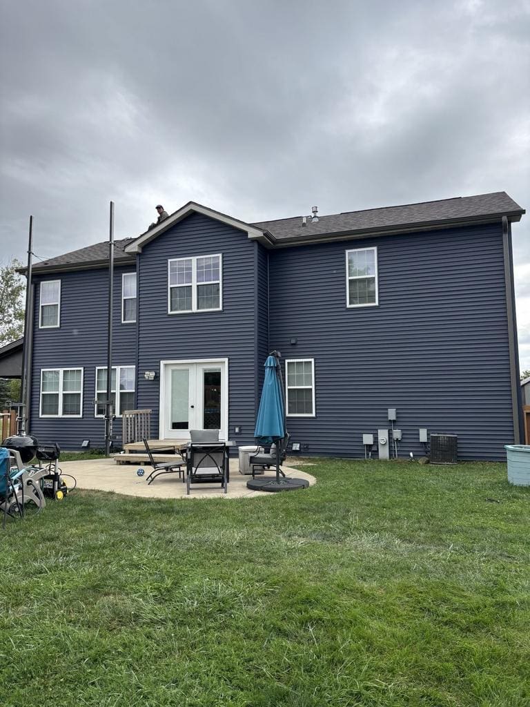 Two-story Wisconsin home after installation of new dark blue horizontal siding